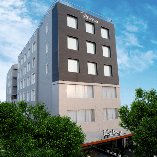 A facade image of TulipInn Zirakpur surrounded by trees in Rishikesh